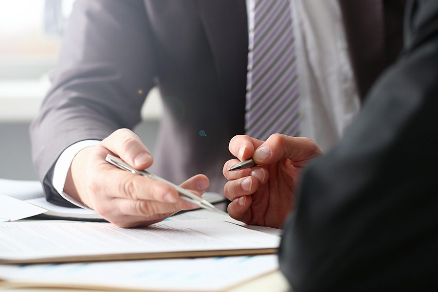 Probate Bonds - Fiduciary Agent and Beneficiary with Forms on a Clipboard and Silver Pen Closeup